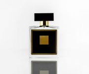 front-view-black-fragrance-bottle-with-yellow-design-isolated-white-wall